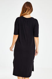 Model Laura wearing size 14 of The 3/4 Sleeve Mid Length Tee Dress in colour Black (Black), from the back