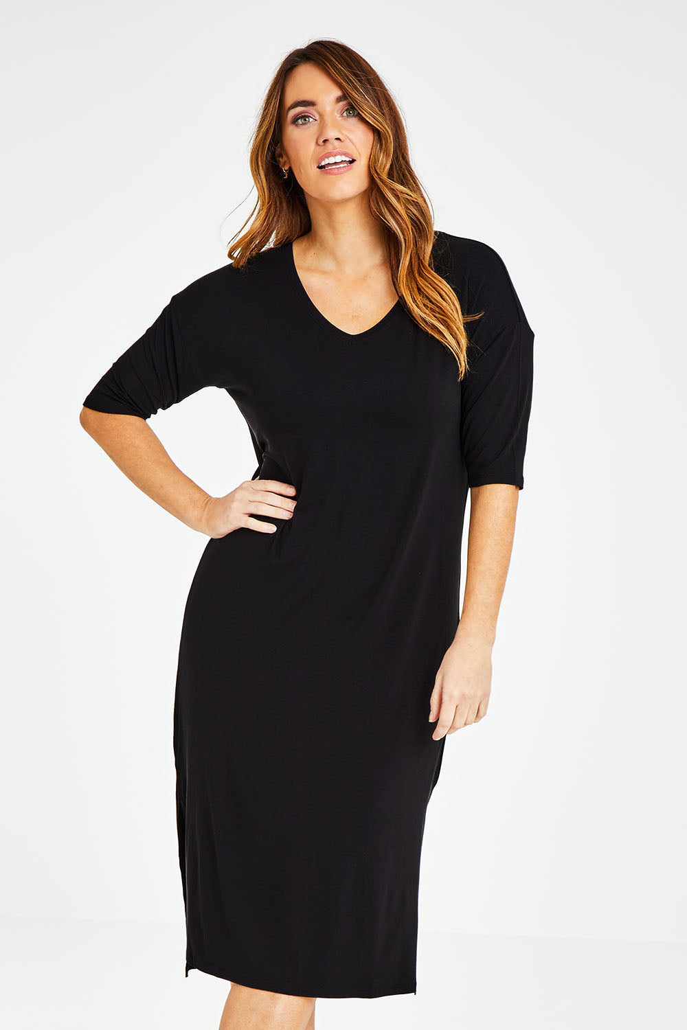 Model Laura wearing size 14 of The 3/4 Sleeve Mid Length Tee Dress in colour Black (Black), from the front, cropped image