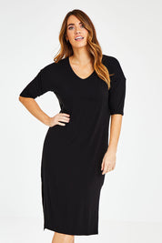 Model Laura wearing size 14 of The 3/4 Sleeve Mid Length Tee Dress in colour Black (Black), from the front, cropped image