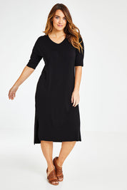 Model Laura wearing size 14 of The 3/4 Sleeve Mid Length Tee Dress in colour Black (Black), from the front, showing the whole outfit