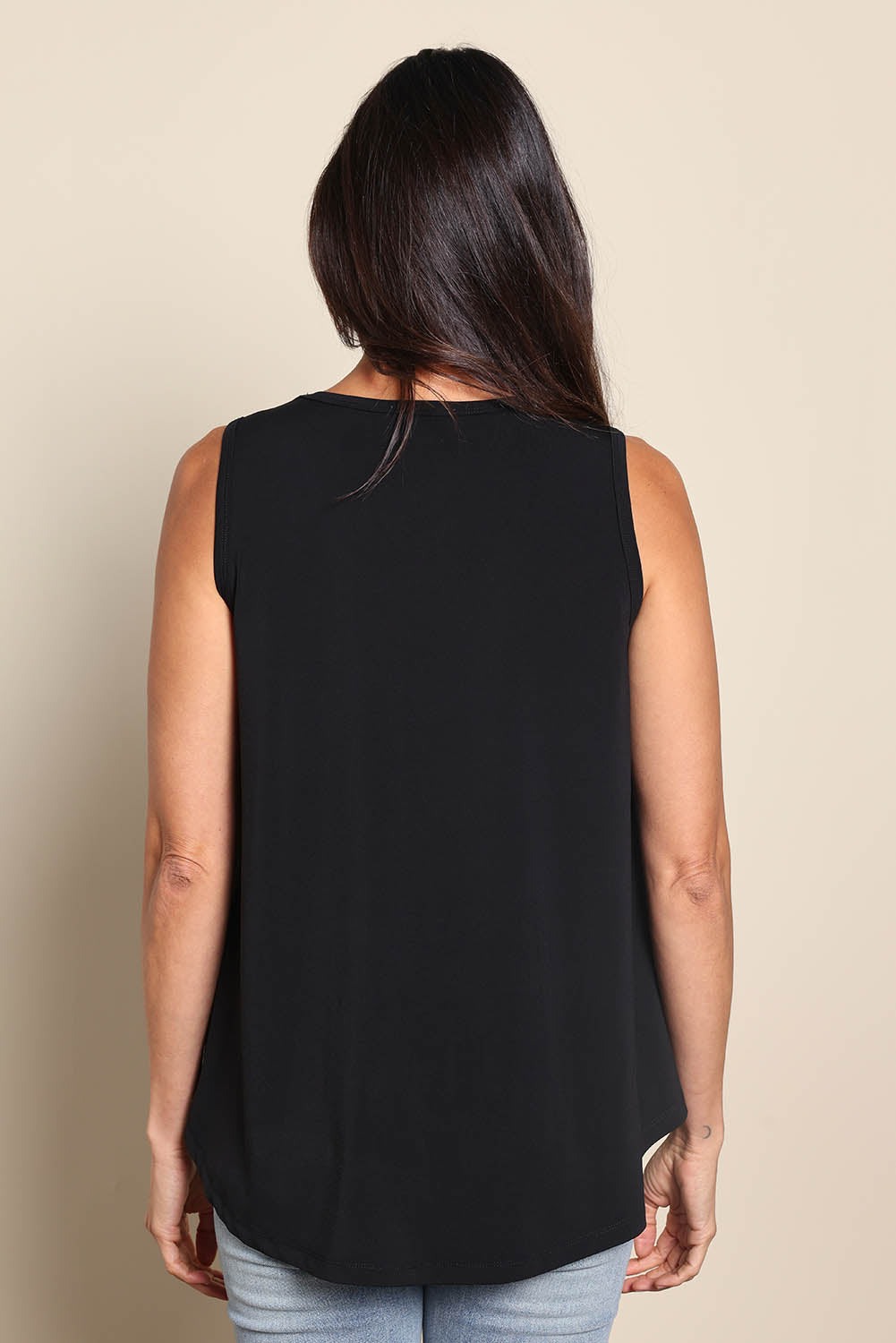 Model Amandam wearing size 10 of the The Essential Swing Tank – Black in colour Black, from the back