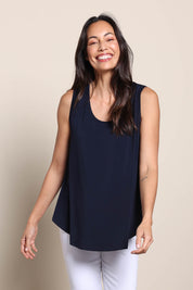 Model Amandam wearing size 10 of the The Essential Swing Tank – Navy in colour Navy, in a cropped view