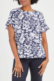 Model Aiyana wearing size 10 of The Frill Sleeve Blouse in colour Navywhite (Blue), from the front, cropped image