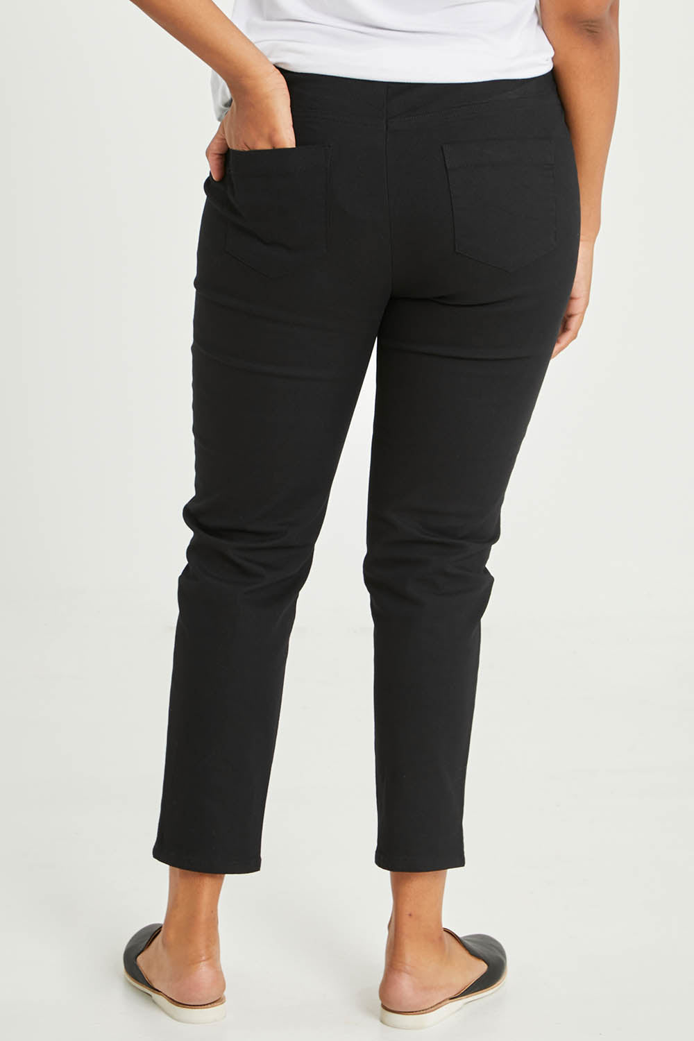 Model Noli wearing size 14 of The 7/8 Pull On Pant in colour Black (Black), from the back