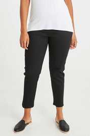 Model Noli wearing size 14 of The 7/8 Pull On Pant in colour Black (Black), from the front, cropped image