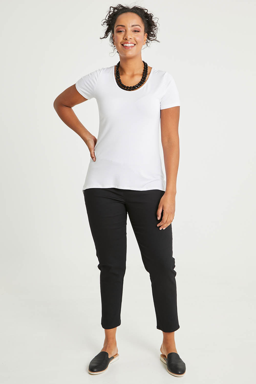 Model Noli wearing size 14 of The 7/8 Pull On Pant in colour Black (Black), from the front, showing the whole outfit