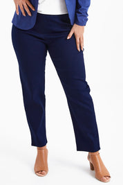 Model Monique wearing size 14 of The 7/8 Pull On Pant in colour Darkdenim (Blue), from the front, cropped image