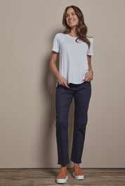 Model Madeline wearing size 10 of The 7/8 Pull On Pant in colour Darknavy (Blue), from the front, showing the whole outfit