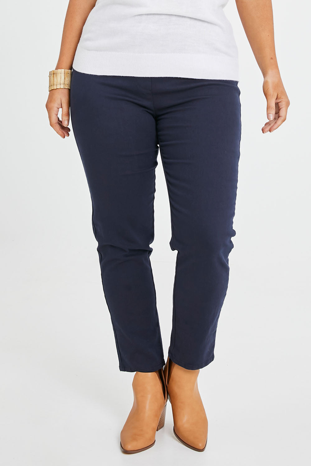 Model Laura wearing size 14 of The 7/8 Pull On Pant in colour Navy (Blue), from the front, cropped image