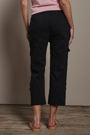 Model Madeline wearing size 10 of The Cotton Blend Cargo Pant in colour Black (Black), from the back