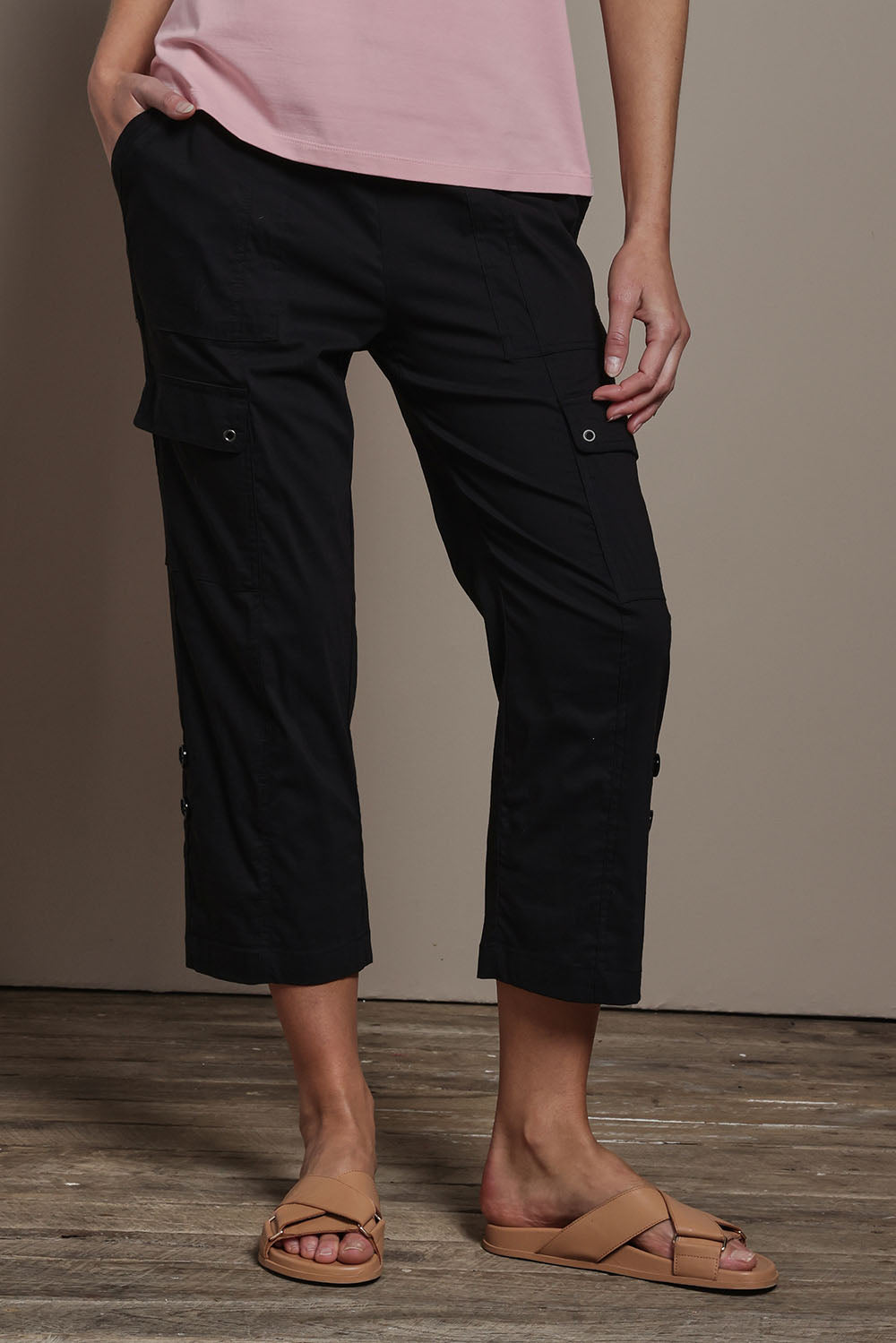 Model Madeline wearing size 10 of The Cotton Blend Cargo Pant in colour Black (Black), from the front, cropped image