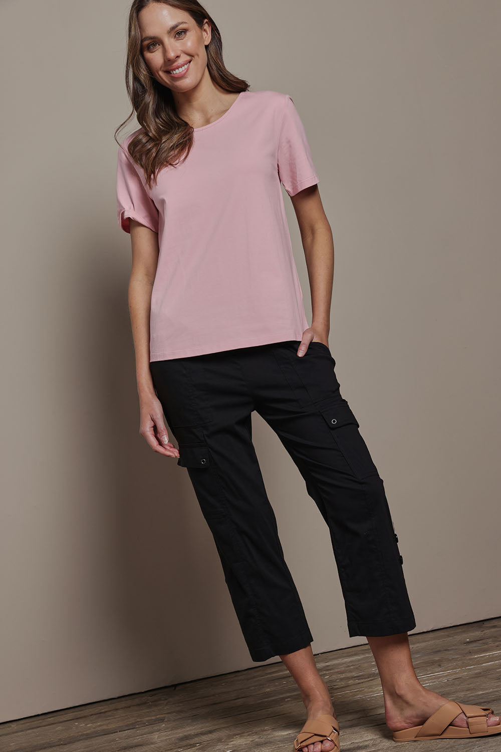 Model Madeline wearing size 10 of The Cotton Blend Cargo Pant in colour Black (Black), from the front, showing the whole outfit