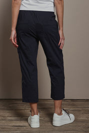Model Madeline wearing size 10 of The Cotton Blend Cargo Pant in colour Navy (Blue), from the back