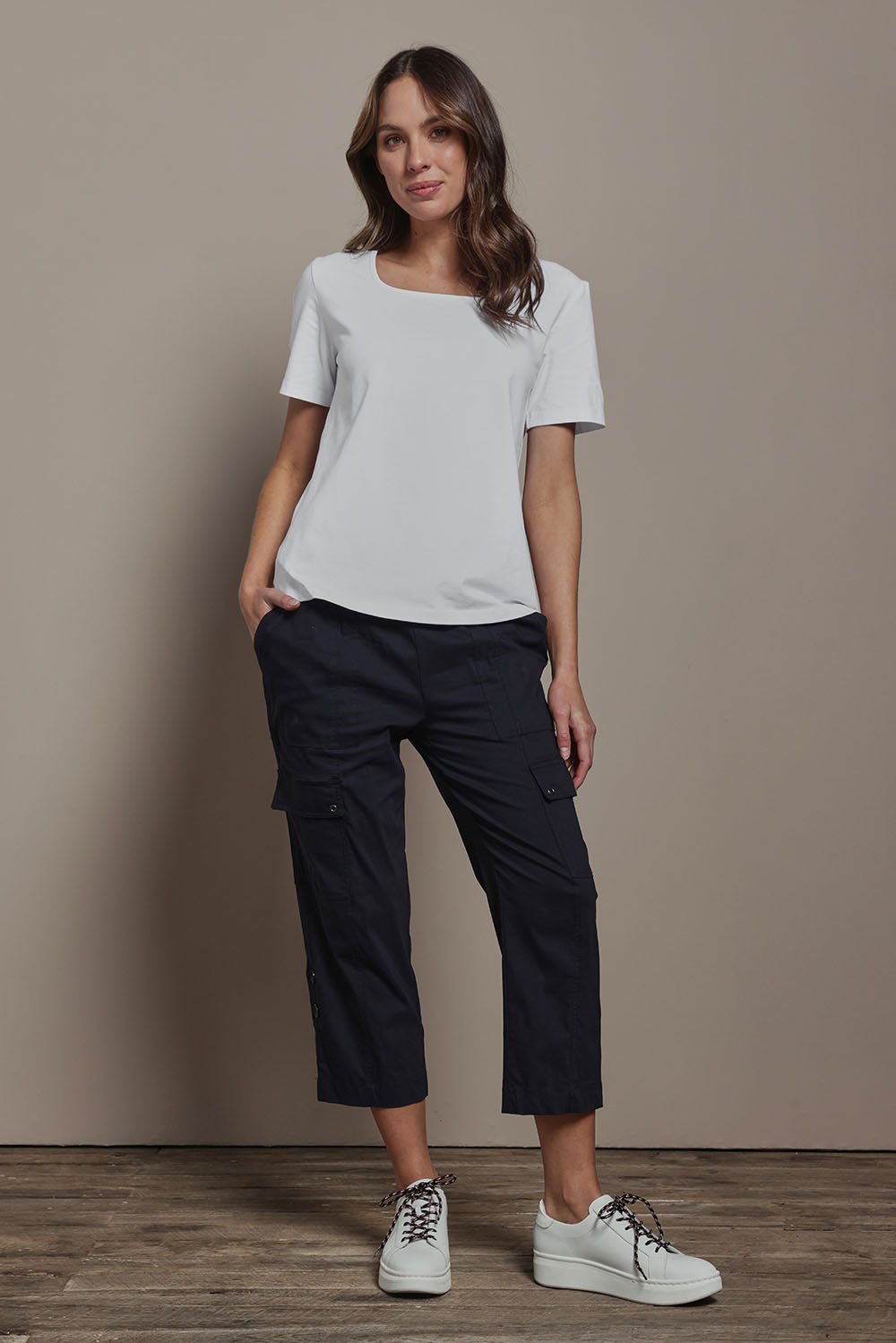 Model Madeline wearing size 10 of The Cotton Blend Cargo Pant in colour Navy (Blue), from the front, showing the whole outfit