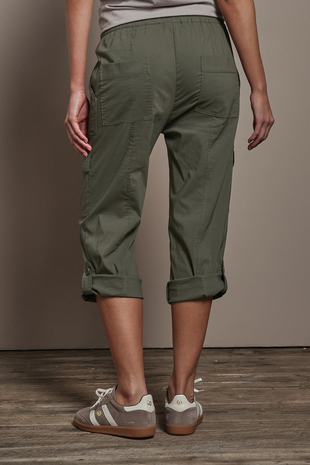 Model Madeline wearing size 10 of The Cotton Blend Cargo Pant in colour Olive (Green), from the back