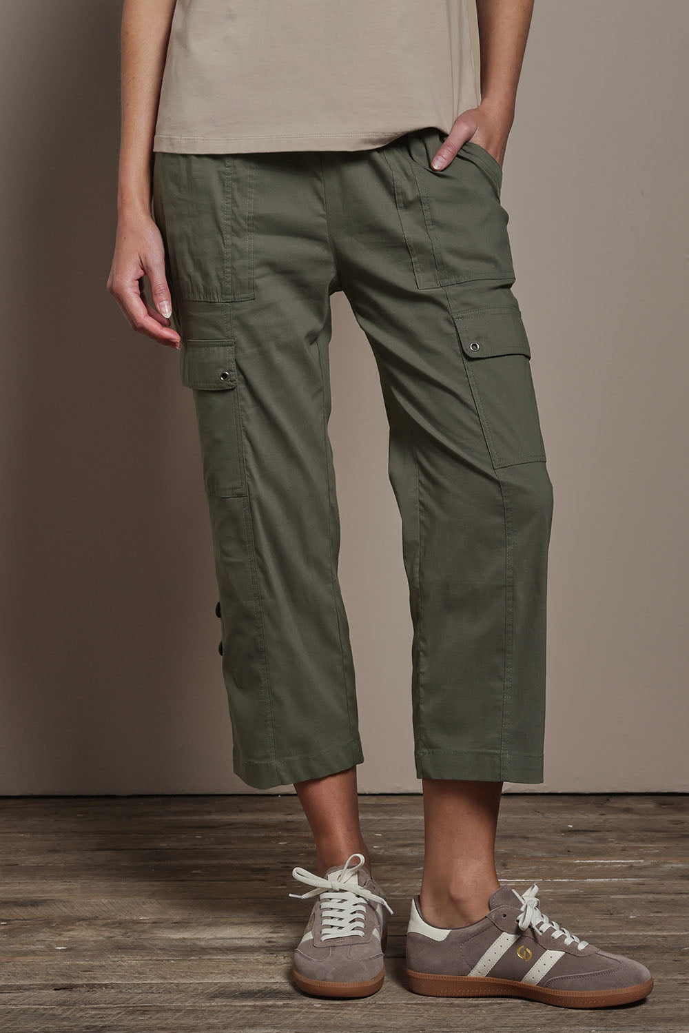 Model Madeline wearing size 10 of The Cotton Blend Cargo Pant in colour Olive (Green), from the front, cropped image