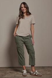 Model Madeline wearing size 10 of The Cotton Blend Cargo Pant in colour Olive (Green), from the front, showing the whole outfit