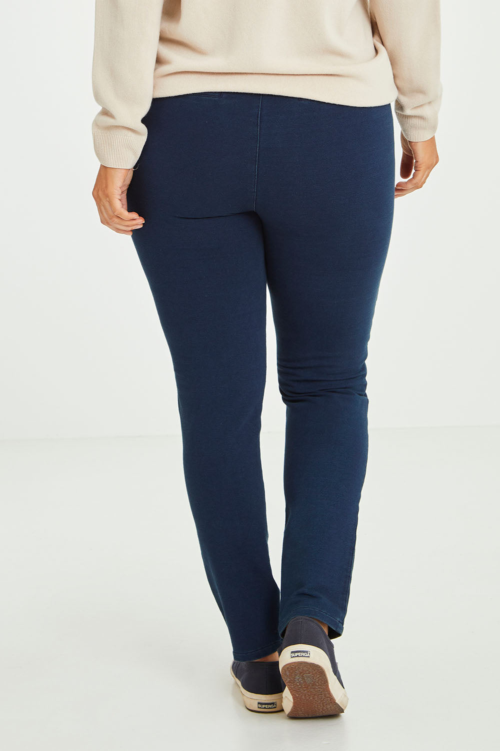 Model Laura wearing size 14 of The Leisure Pull On Pant in colour Navy (Blue), from the back
