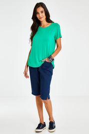 Model Vitoria wearing size 10 of The Bermuda Pull On Short in colour Denim (Blue), from the front, showing the whole outfit