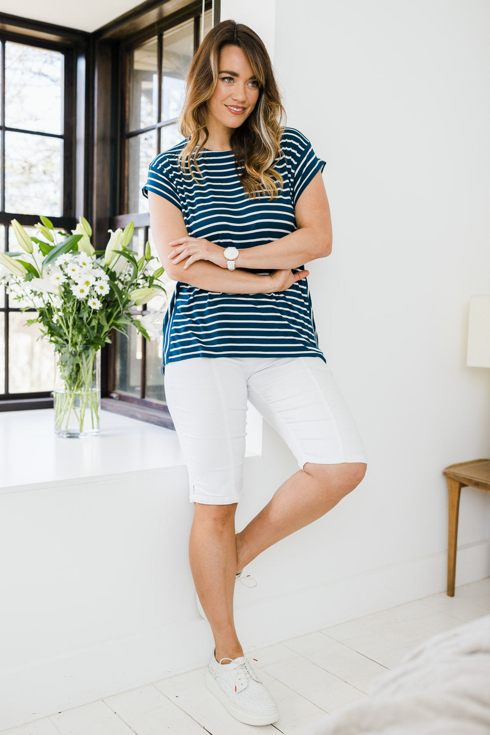 Model Laura wearing size 14 of The Bermuda Pull On Short in colour White (White), from the front, showing the whole outfit