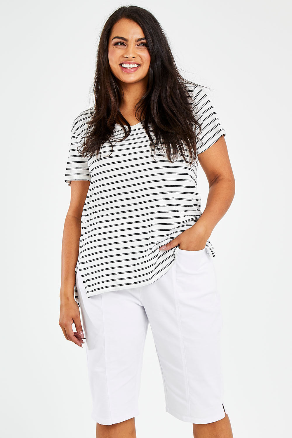 Model Sasha-Lee wearing size 16 of The Bermuda Pull On Short in colour White (White), from the front, cropped image