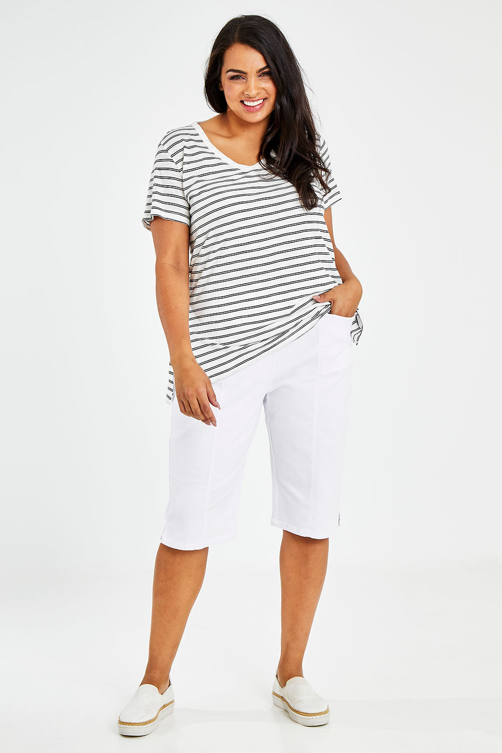 Model Sasha-Lee wearing size 16 of The Bermuda Pull On Short in colour White (White), from the front, showing the whole outfit