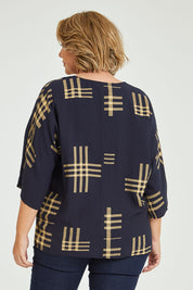 Model Fiona wearing size 16 of The Relax Fit Printed Top in colour Navycamel (Blue), from the back