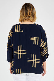 Model Jess wearing size 14 of The Relax Fit Printed Top in colour Navycamel (Blue), from the back