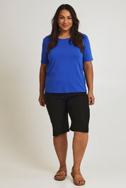 Model Ashleigh wearing size 16 of The Cargo Short in colour Black (Black), from the front, showing the whole outfit