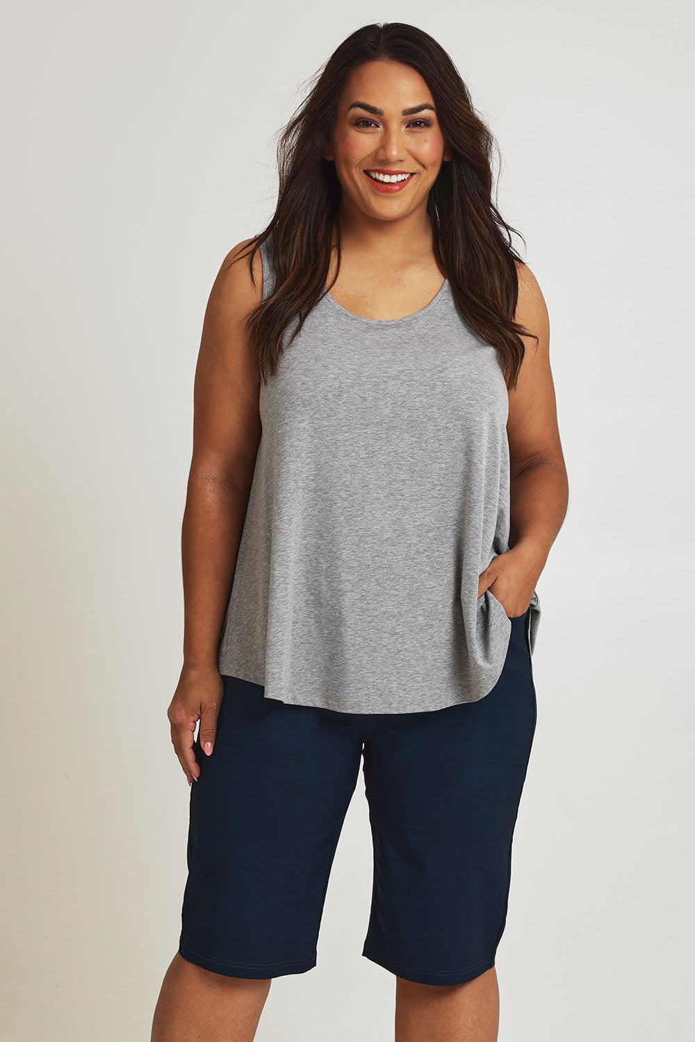 Model Ashleigh wearing size 16 of The Cargo Short in colour Petrol (Blue), from the front, cropped image