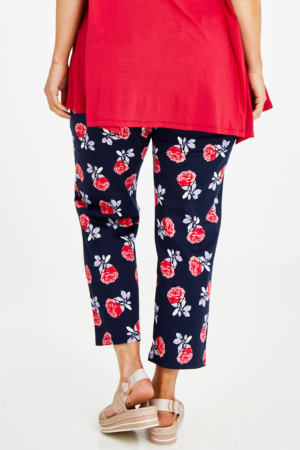Model Laura wearing size 14 of The Printed Cotton Pull On Pant in colour Navyfloral (Blue), from the back