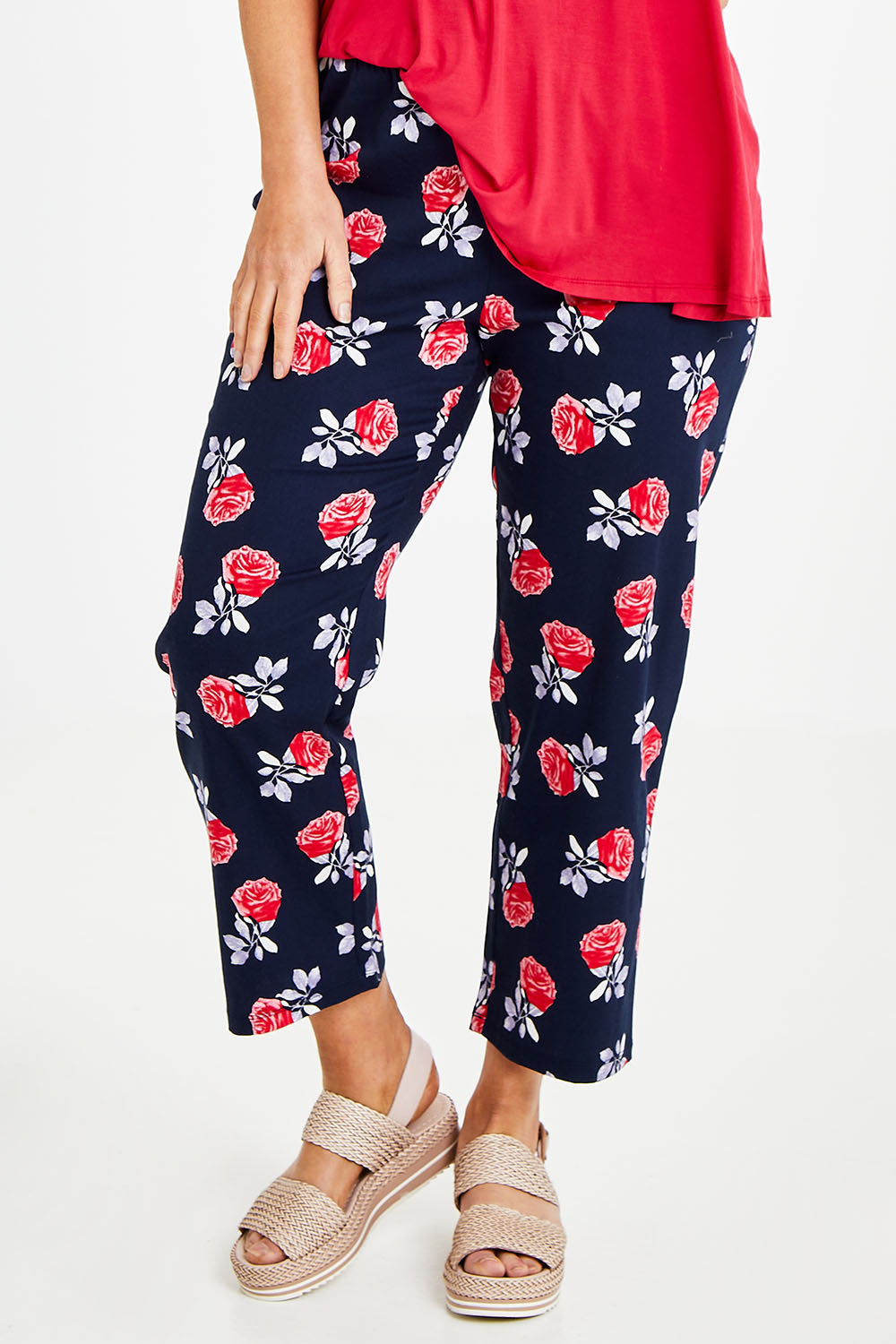 Model Laura wearing size 14 of The Printed Cotton Pull On Pant in colour Navyfloral (Blue), from the front, cropped image