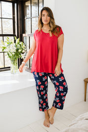 Model Laura wearing size 14 of The Printed Cotton Pull On Pant in colour Navyfloral (Blue), from the front, showing the whole outfit