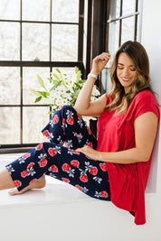 Model Laura wearing size 14 of The Printed Cotton Pull On Pant in colour Navyfloral (Blue), from the front, showing the whole outfit
