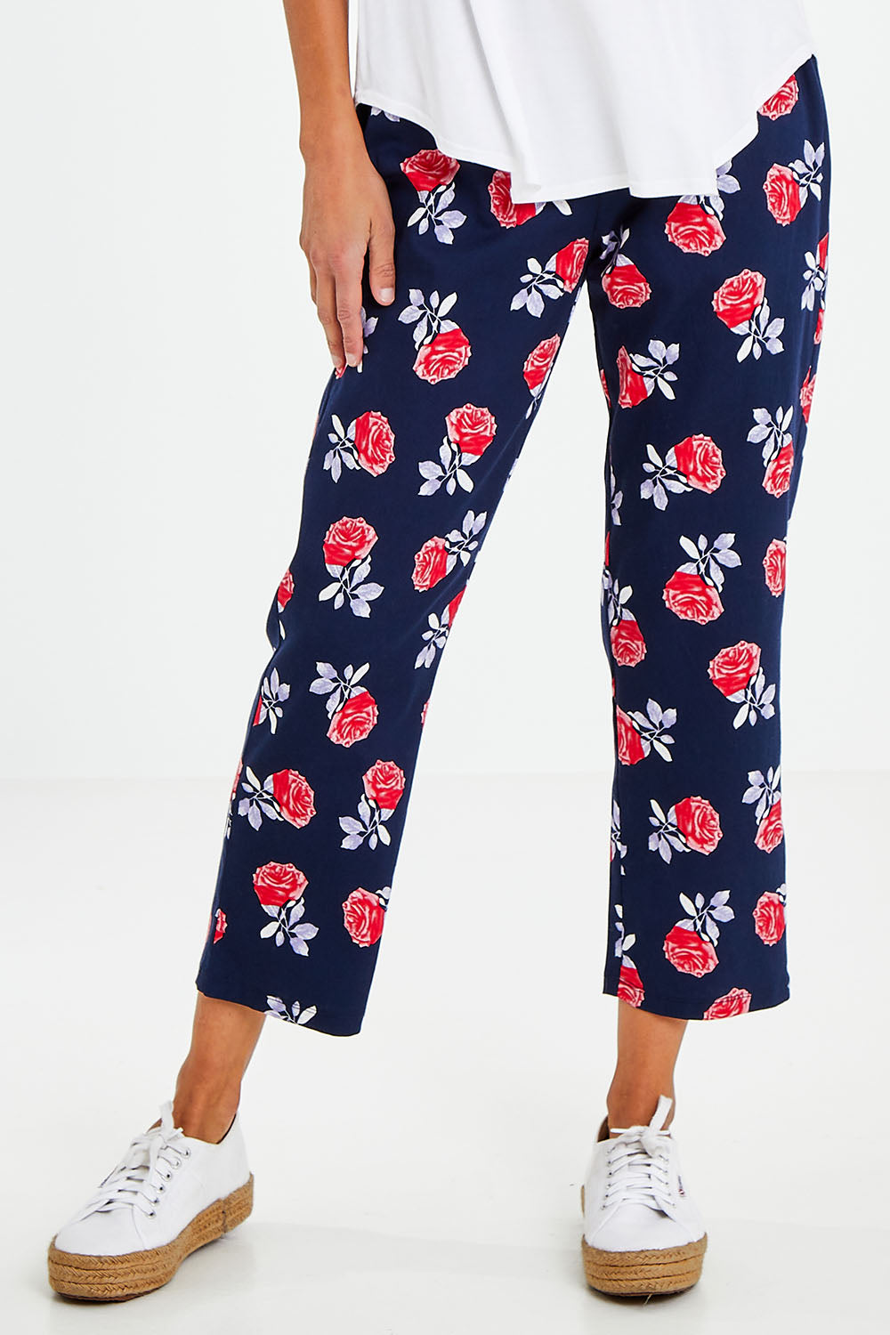 Model Vitoria wearing size 10 of The Printed Cotton Pull On Pant in colour Navyfloral (Blue), from the front, cropped image