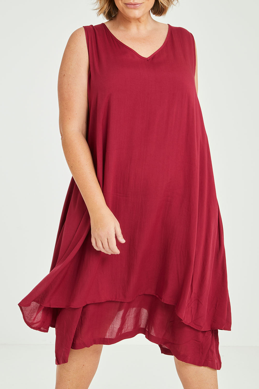 Model Fiona wearing size 16 of The Everyday Layered Dress in colour Cherryred (Red), from the front, cropped image