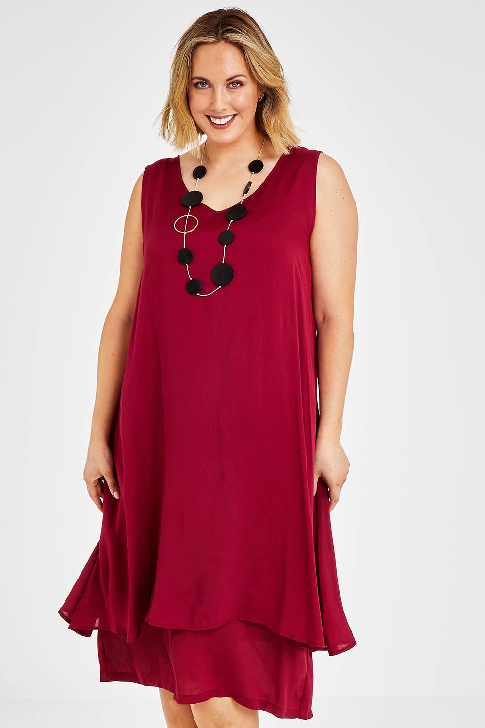 Model Jess wearing size 14 of The Everyday Layered Dress in colour Cherryred (Red), from the front, cropped image