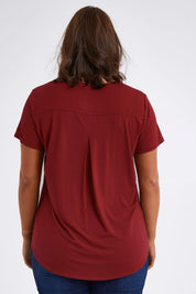 Model Monique wearing size 14 of The Back Pleat Detail Tee in colour Cherryred (Red), from the back