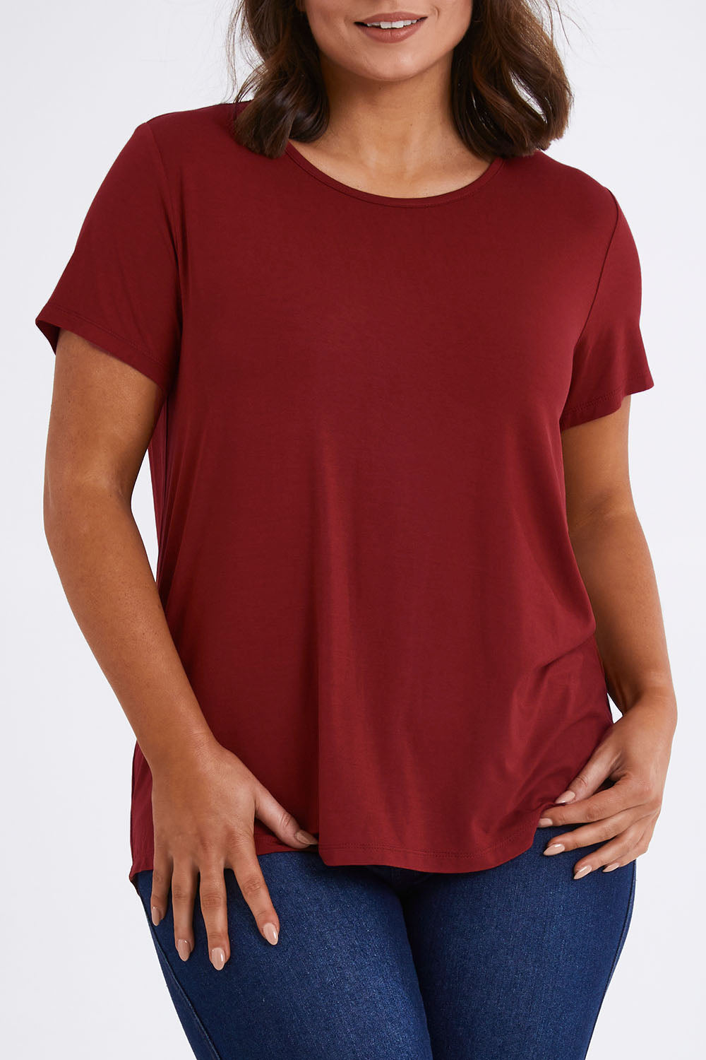Model Monique wearing size 14 of The Back Pleat Detail Tee in colour Cherryred (Red), from the front, cropped image