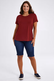 Model Monique wearing size 14 of The Back Pleat Detail Tee in colour Cherryred (Red), from the front, showing the whole outfit