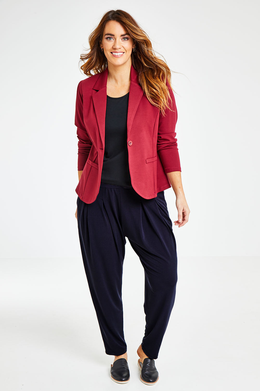 Model Laura wearing size 14 of The Pleat Detail Pull On Pant in colour Graphite (Grey), from the front, showing the whole outfit