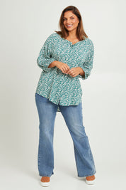 Model Monique wearing size 14 of The Perfect Relaxed Fit Shirt in colour Greenivory (Green), from the front, showing the whole outfit