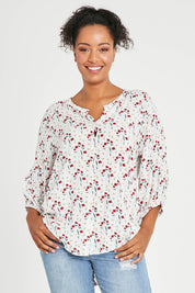 Model Noli wearing size 14 of The Perfect Relaxed Fit Shirt in colour Redfloral (White), from the front, cropped image