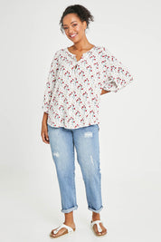 Model Noli wearing size 14 of The Perfect Relaxed Fit Shirt in colour Redfloral (White), from the front, showing the whole outfit