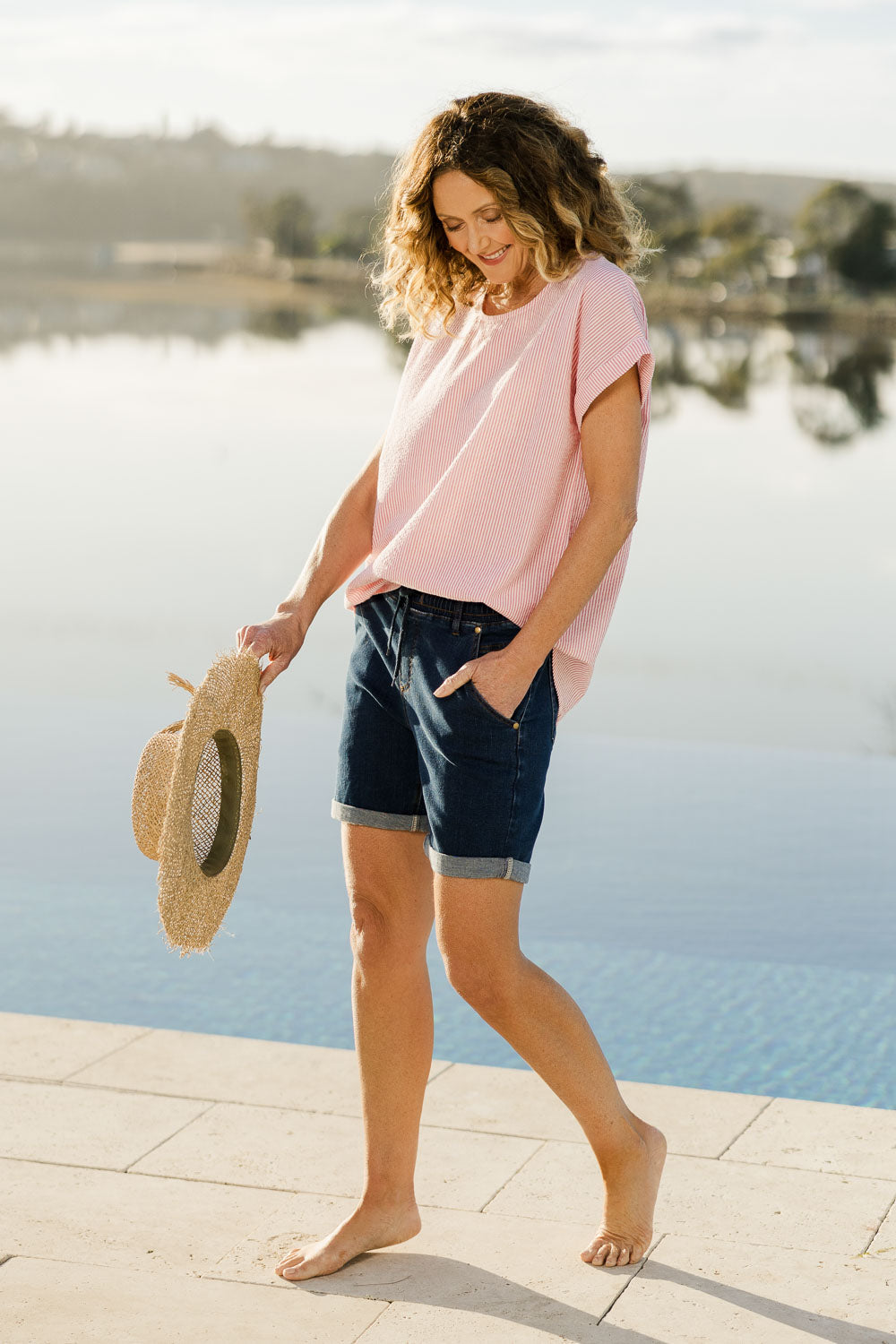 Model Emma wearing size 10 of The Weekender Shorts in colour Darkdenim (Blue), from the front, showing the whole outfit