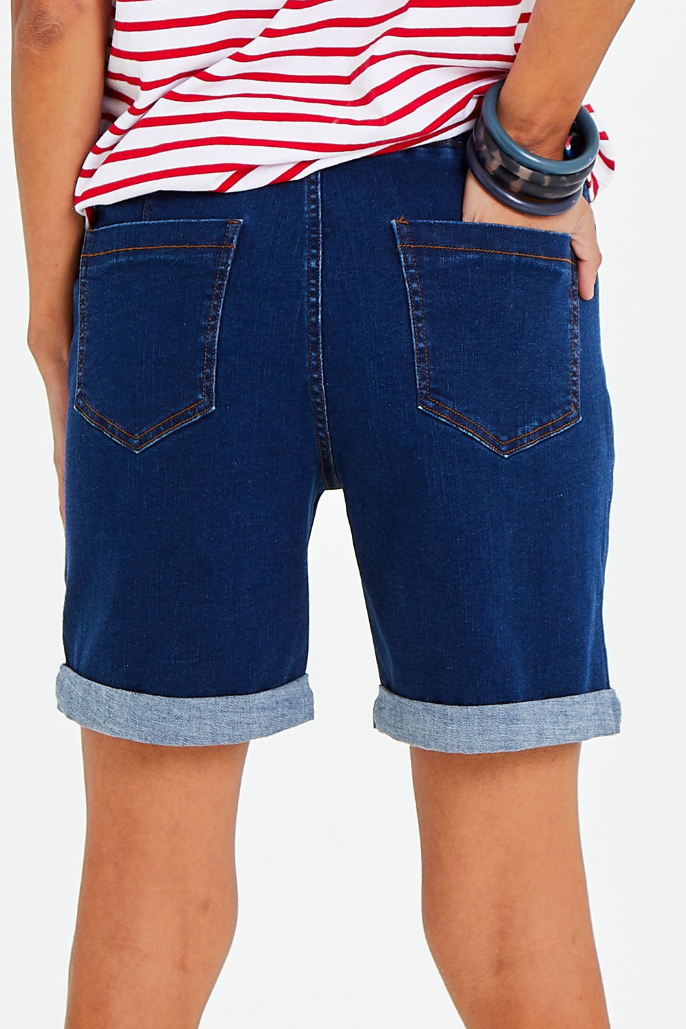 Model Vitoria wearing size 10 of The Weekender Shorts in colour Darkdenim (Blue), from the back