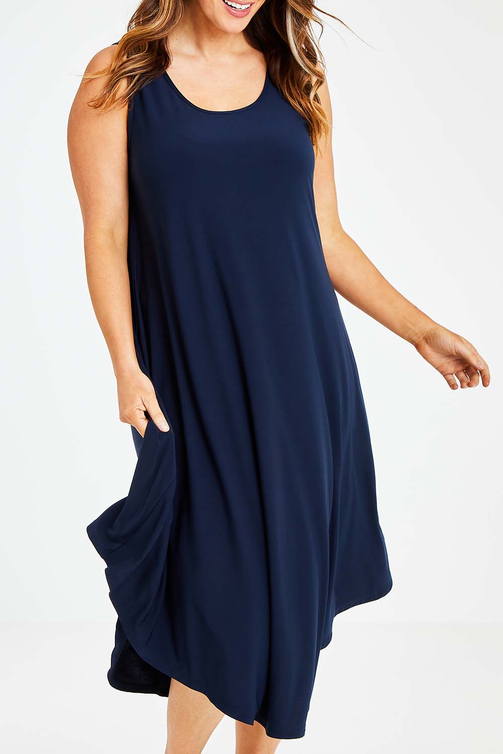 Model Laura wearing size 14 of The Recycled High Low Dress in colour Navy (Blue), from the front, cropped image