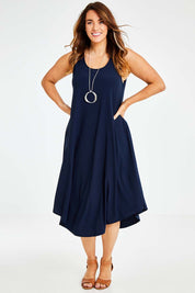 Model Laura wearing size 14 of The Recycled High Low Dress in colour Navy (Blue), from the front, showing the whole outfit