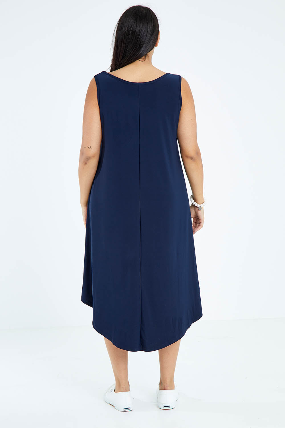 Model Sasha-Lee wearing size 16 of The Recycled High Low Dress in colour Navy (Blue), from the back