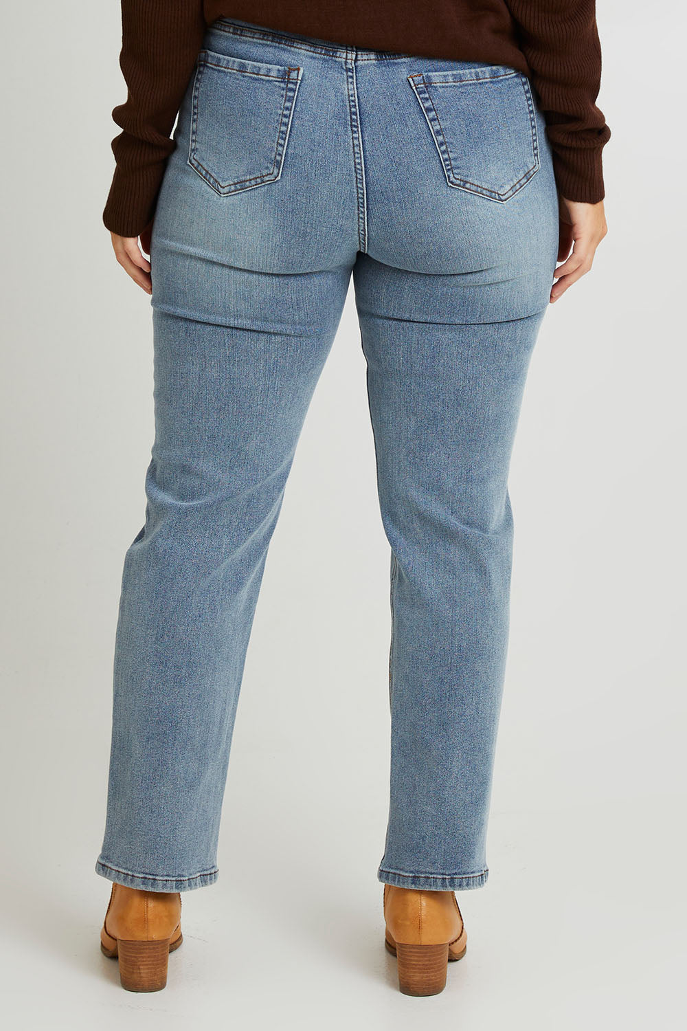 Model Laura wearing size 14 of The Keepers Highwaisted Straight Jean in colour Lightdenim (Blue), from the back